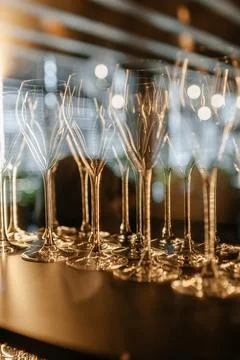 Closeup of colorful wine glasses.Wine glasses on a glass shelf with lighting. Stock Photos