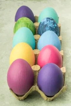 Closeup colorfully painted easter eggs on green background Stock Photos