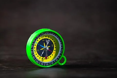 A closeup of a compass on a black background Stock Photos