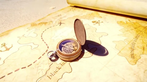Closeup of compass over stained yellowed paper sheet with part of treasure ma Stock-Footage 257870123