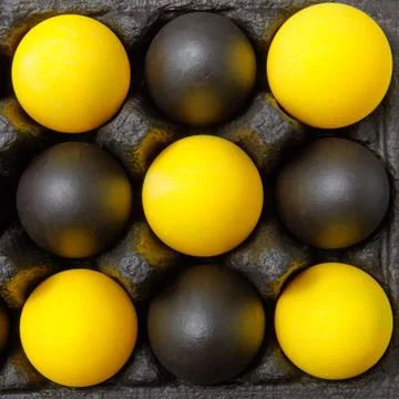 Closeup composition of multicolored yellow black eggs in the form of a pattern Foto stock