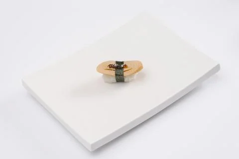 Closeup composition of one fresh salmon sashimi sushi with caviar on top on w Foto stock