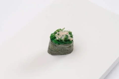 Closeup composition of one fresh salmon sashimi sushi with caviar on top on w Stock Photos
