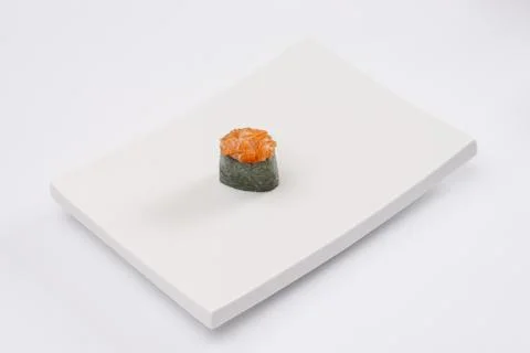 Closeup composition of one fresh salmon sashimi sushi with caviar on top on w Stock Photos