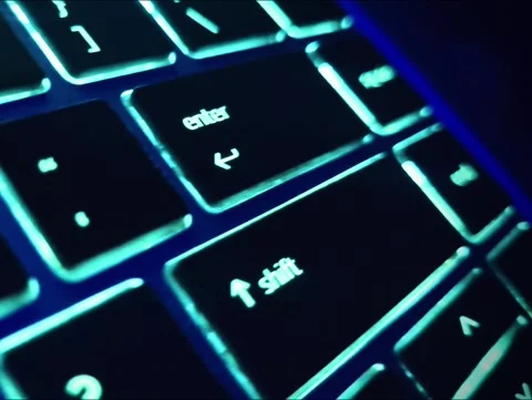 Closeup of computer backlit keyboard with Enter key motion zoom in out Stockbeeldmateriaal 258377967