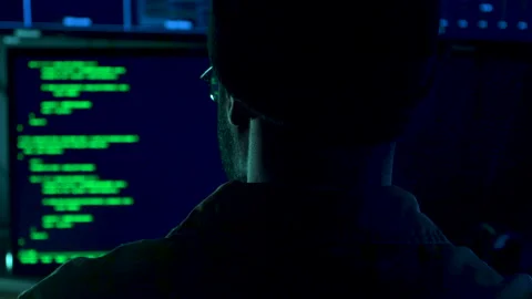 Closeup of a computer hacker in front of a screen with computer code Stock Footage 282179849