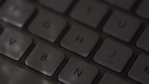 Closeup of computer keyboard with light shining from window Stock Footage 205099837