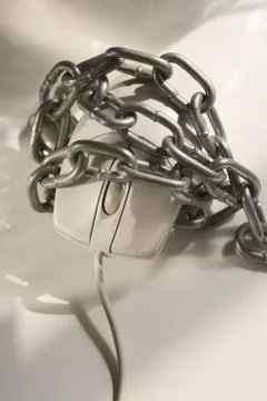 Closeup of computer mouse covered in chains Stock Photos