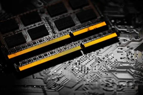 Closeup of computer RAM chip and motherboard on dark background Stock Photos
