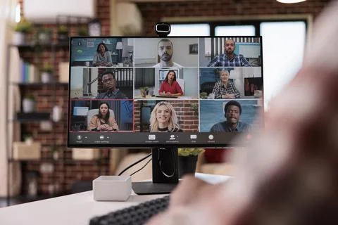 Closeup of computer screen with video call software app showing team of Foto stock