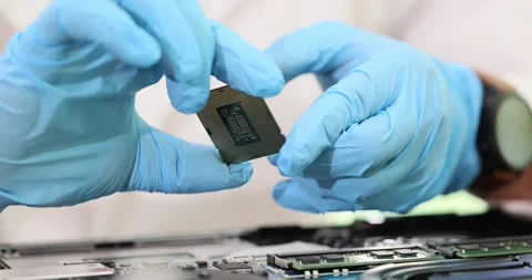 Closeup of computer technician in gloves holding processor processor chip in Stock Footage 256427796