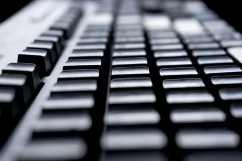 The closeup of the computer's black keyboard pc that is blank and blurred f.. Фото