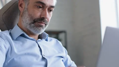 CloseUp of Concentrated freelance Businessman using laptop Device at Home office Stock Footage 144197858