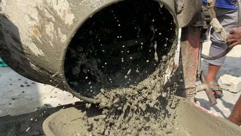 Closeup of a concrete mixer machine rotating and pouring wet cement on a constru Stock Footage 334533806