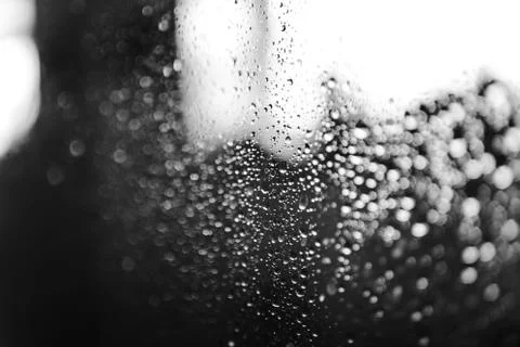 Closeup of condensation patterns on glass window, water droplets with light Stock Photos