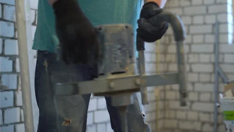 Closeup of construction worker mixing plaster solution with electric mixer Stock Footage 102165731