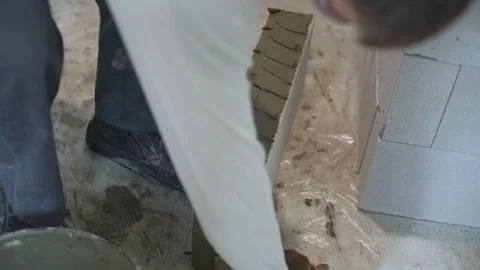 Closeup of construction worker putting mortar on aerated concrete block Stock Footage 102908767