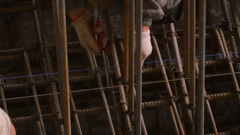 Closeup of construction workers installing rebar for concrete on a job site Video stock 103554326