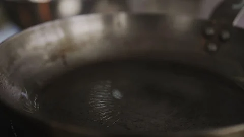 Closeup cook man put meat on the pan oil Video stock 123127928