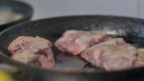 Closeup cook man put meat on the pan oil Stock Footage 127086516