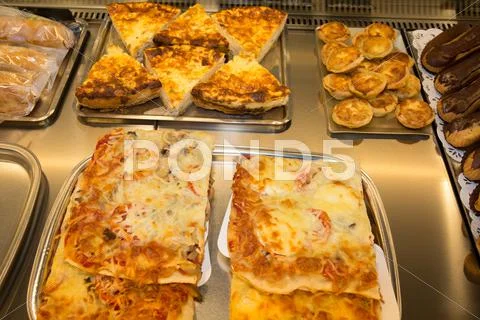 Closeup of cooked pizza slices in a bakery Stock Photos