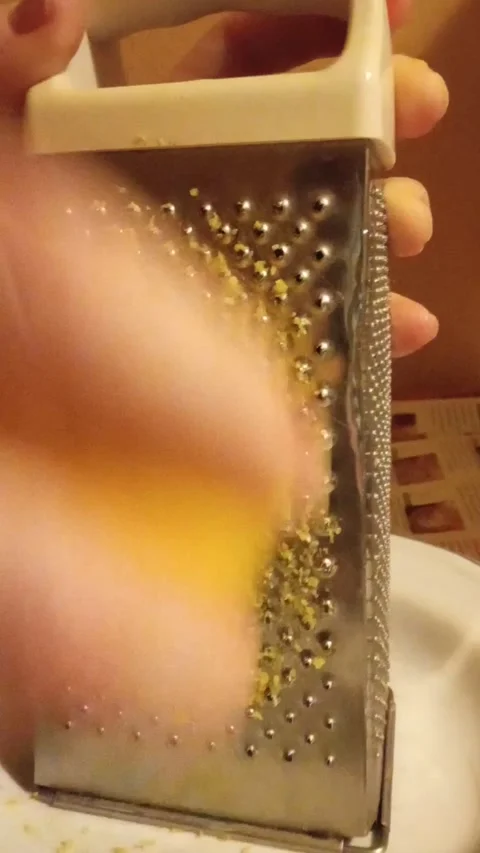 Closeup cooking action of grating lemon for food preparation Stock Footage 326064764