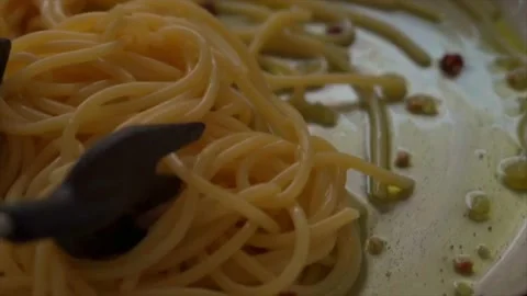 Closeup of cooking aglio olio e peperoncino spaghetti on frying pan Stock Footage 233043552