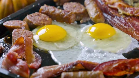 Closeup of Cooking Bacon and Egg in frying Pan. Fast and easy breakfast concept. 스톡 동영상 334643397