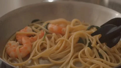 Closeup of Cooking garlic prawn spaghetti in a frying pan Stock Footage 246140761