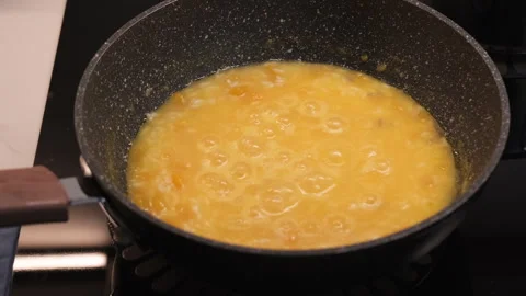 Closeup cooking risotto boiling bubbles in stainless pot Stockbeeldmateriaal 330266817