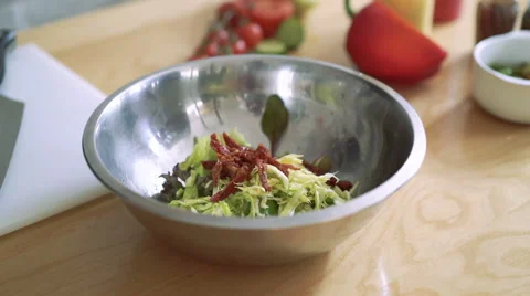 Closeup cooking a salad, strewing it carrots in the bowl 4k 動画素材 61962057