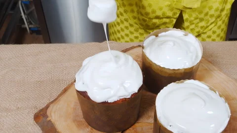 Closeup cooking traditional Easter cake. Female hands decorating a festive Stock Footage 173452052