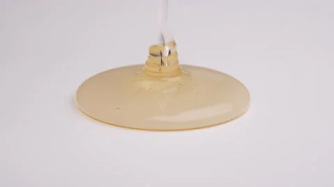 Closeup of a corn syrup poured on a white surface. Stock Footage 201337923