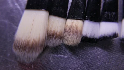 Closeup of cosmetics makeup brushes kit in motion. 4K UHD Stock Footage 73339456