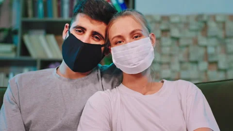 Closeup couple with a protective mask looking straight to the camera and have a Stock Footage 135599226