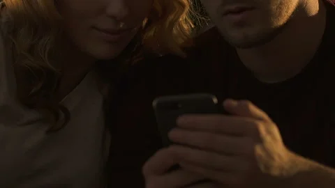 Closeup of couple using smartphone together, ordering food online for dinner Stock Footage 97914473