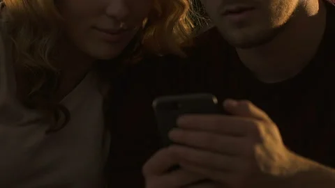 Closeup of couple using smartphone together, ordering food online for dinner Stock Footage 97919805