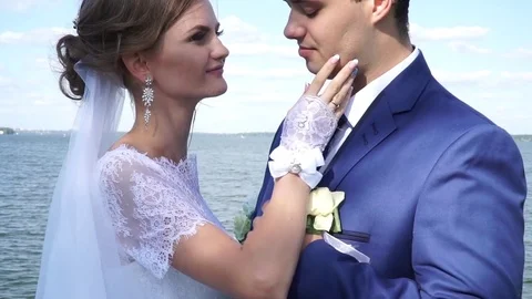 Closeup of a couple's hands standing on the river bank Stock Footage