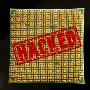 A closeup of a CPU processor with a red "HACKED" stamp - internet security co 写真素材