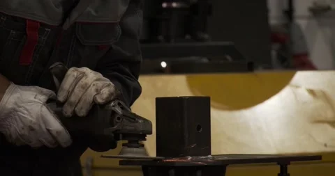 Closeup craftsman hands welding seams with angle grinder working at manufacture Stock-Footage 167338541
