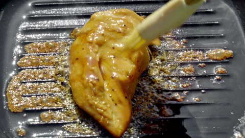 Closeup of crispy chicken being brushed with caramel sauce Stock Footage 324580137