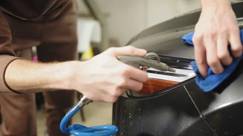 Closeup cropped image of hand of young man worker of auto service, wiping and Stock Footage 233788563