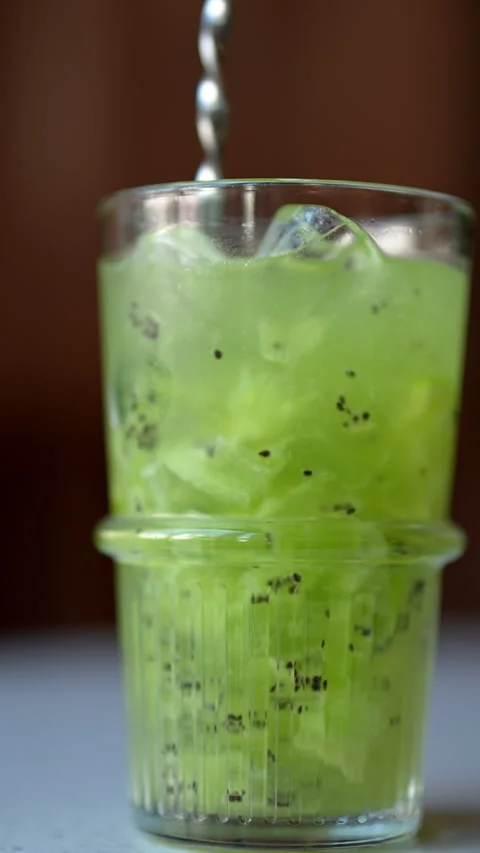 Closeup cropped shot of bartender stirring alcoholic cocktail with bar spoon on Stock Footage 278147893