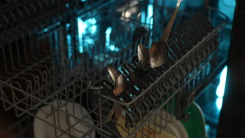 Closeup cropped shot of unrecognizable man loading backlit dishwasher machine Stock Footage 238474542