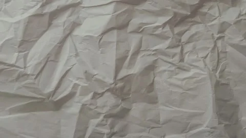 Closeup of a crumpled sheet of light pink paper, animated background Video stock 333977618