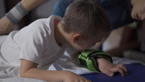Closeup of a crying boy. Lies on his stomach. Cries a lot. 動画素材 115848944