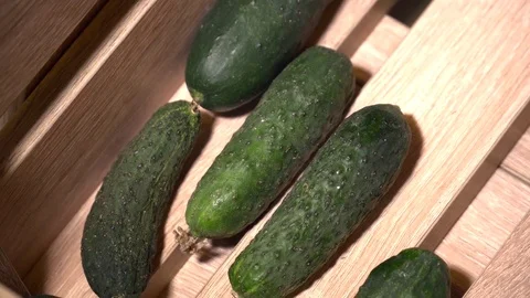 Closeup of cucmbers in the wooden box Stock Footage