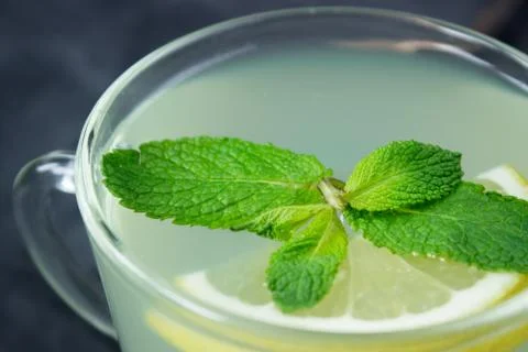 Closeup of Cup of Ginger tea with lemon and mint Stock Photos