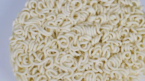 Closeup of curled instant noodles. Macro shot of coiled dry noodles. Highresolut Stock Footage 331838658