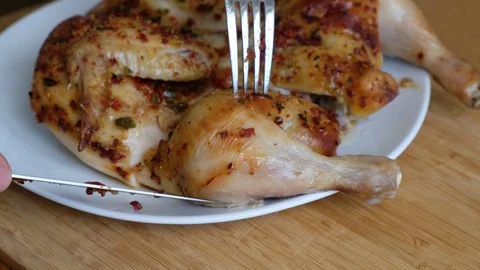 Closeup of a cut piece of fried chicken on a wooden background Stock Footage 126899993